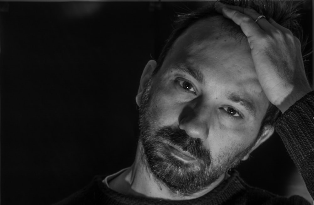 a black and white photo of a man with a beard