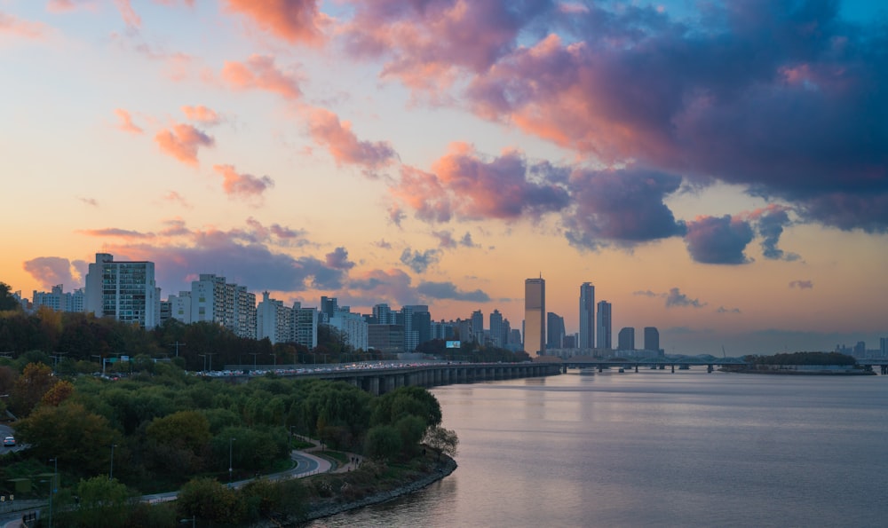 a view of a city and a river at sunset