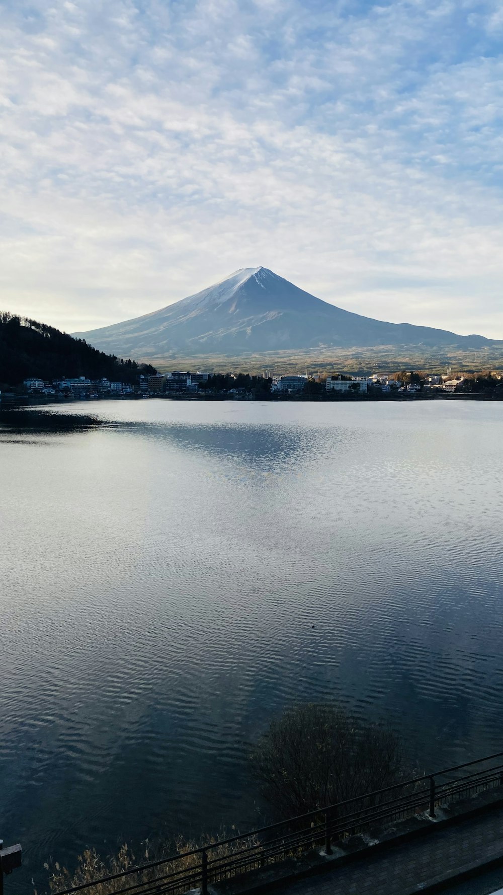 a large body of water with a mountain in the background