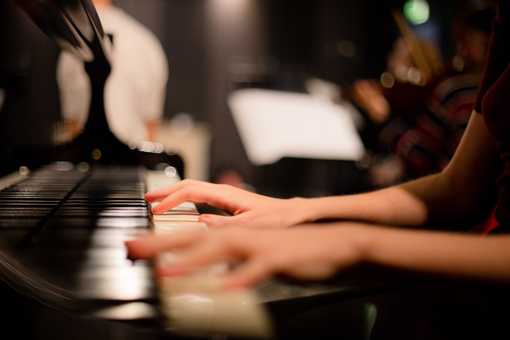 a close up of a person playing a piano