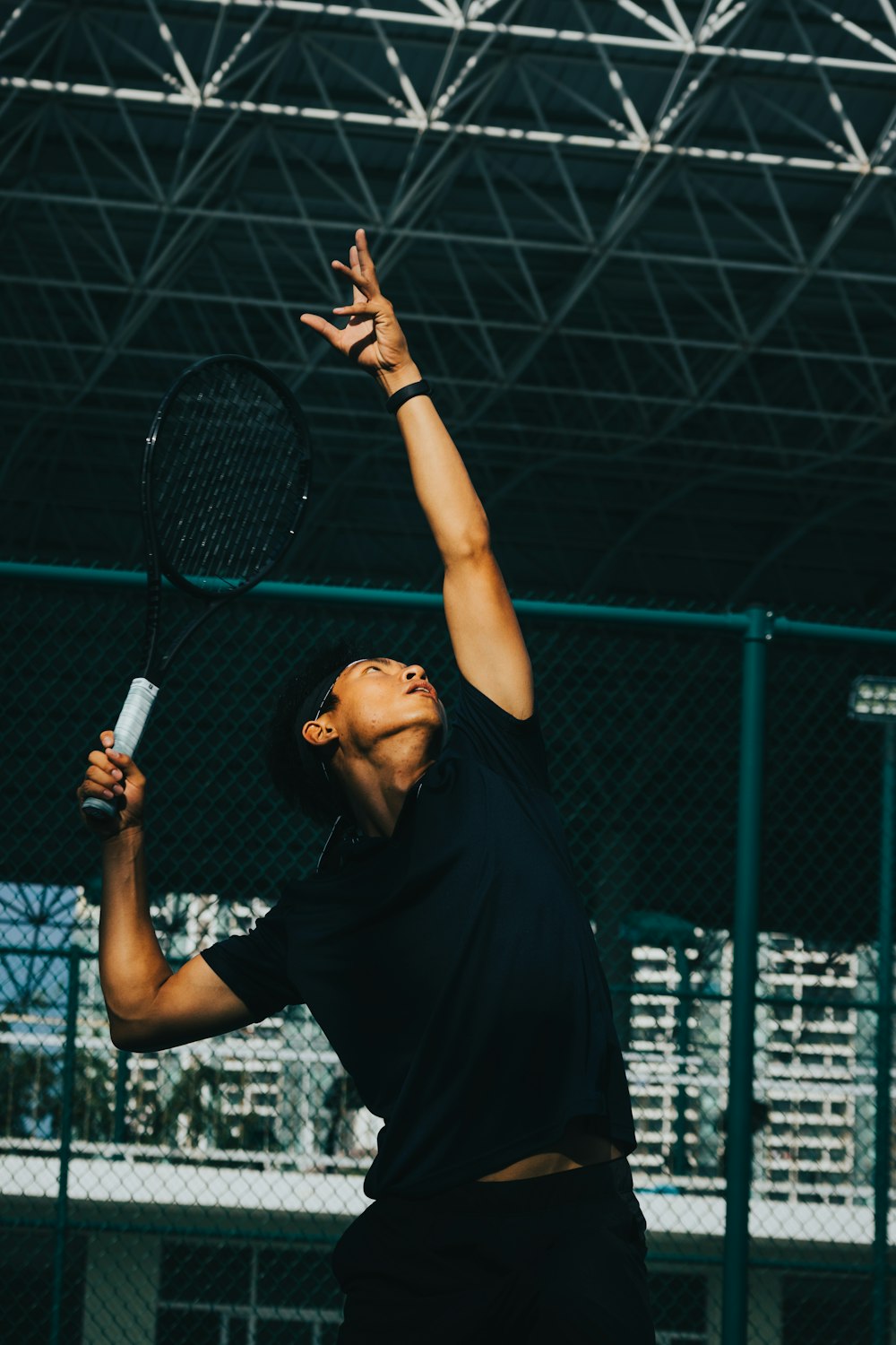 a man holding a tennis racquet on top of a tennis court