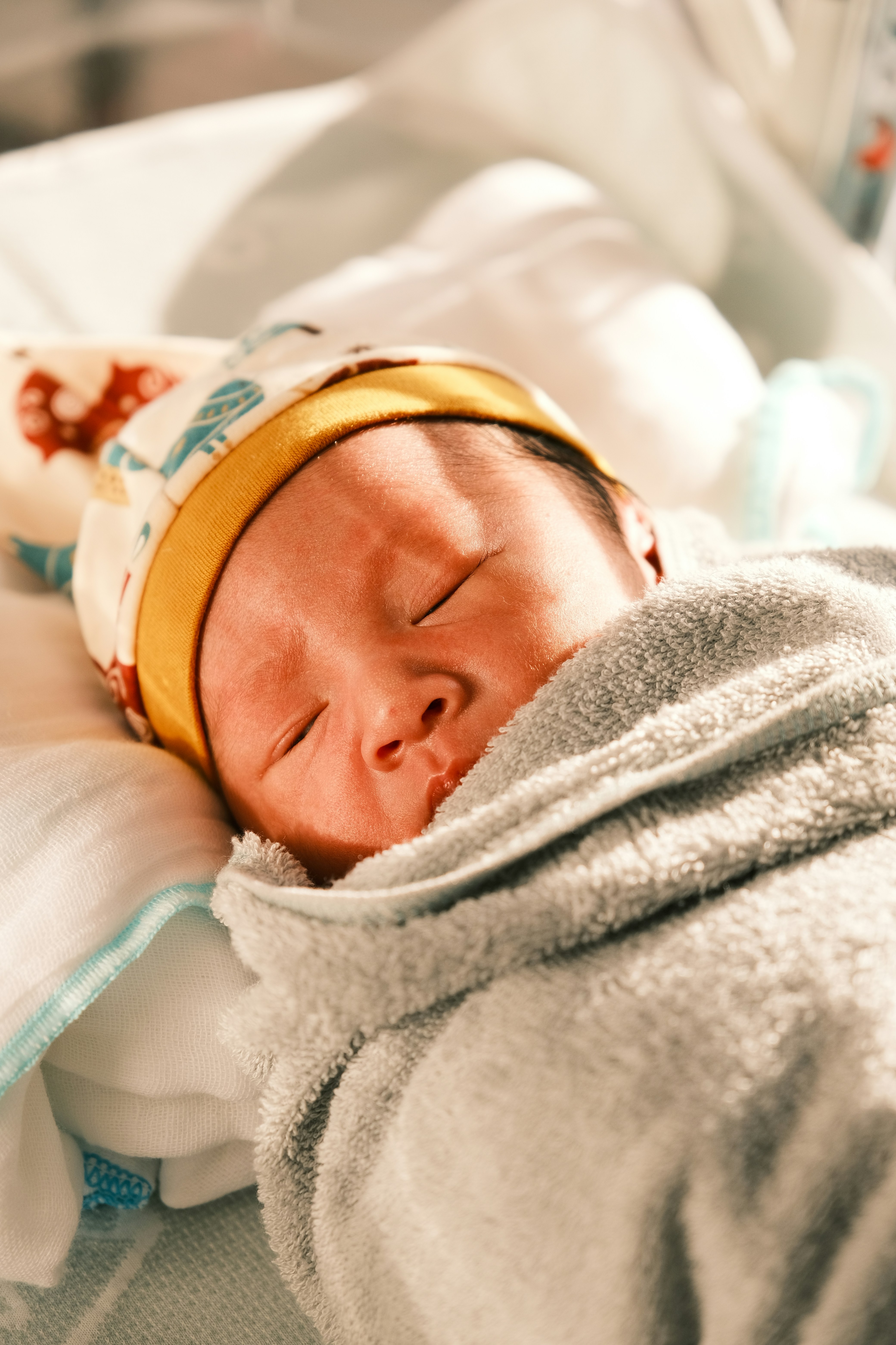 A newborn baby is wrapped in a blanket photo Free Newborn Image on