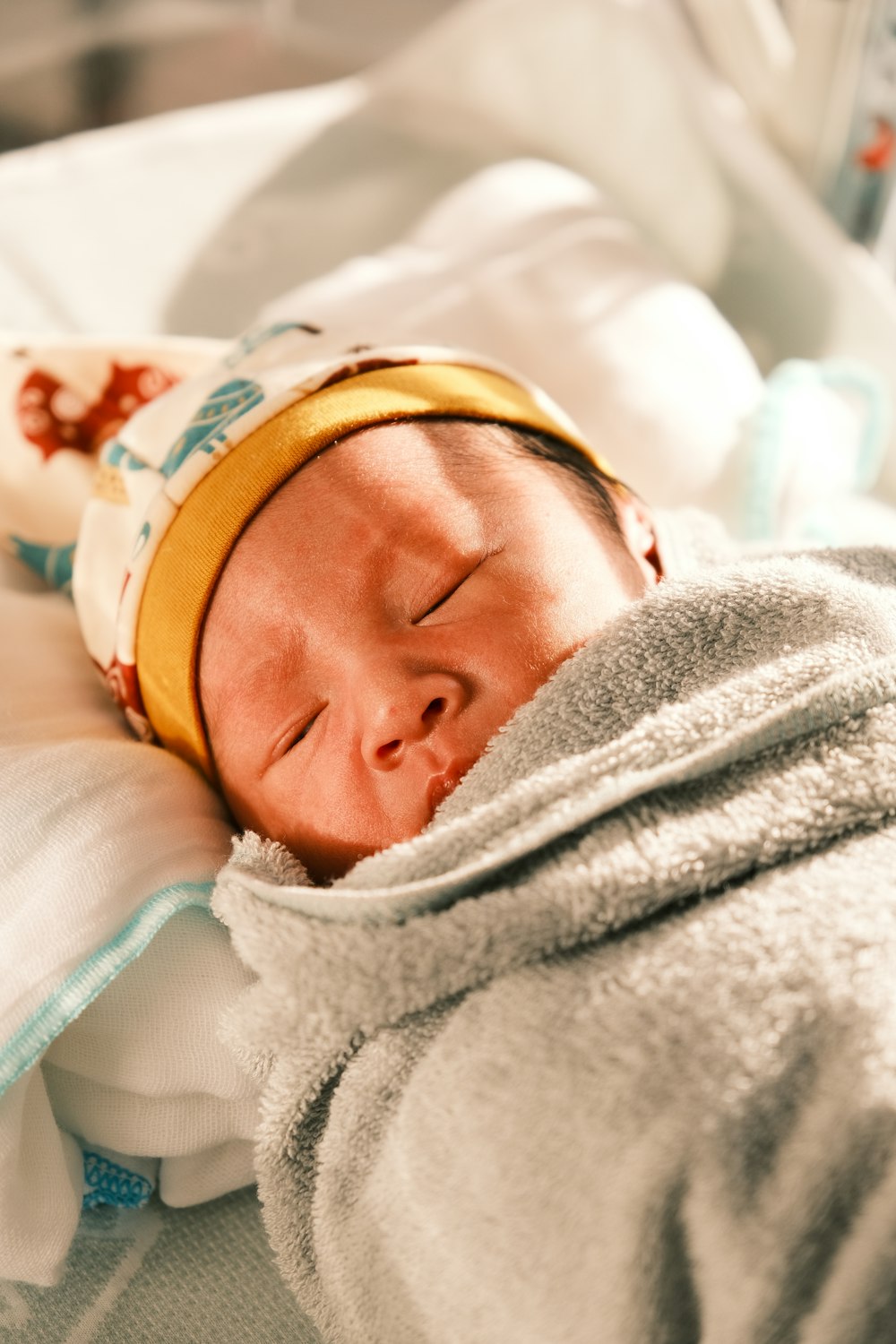 a newborn baby is wrapped in a blanket
