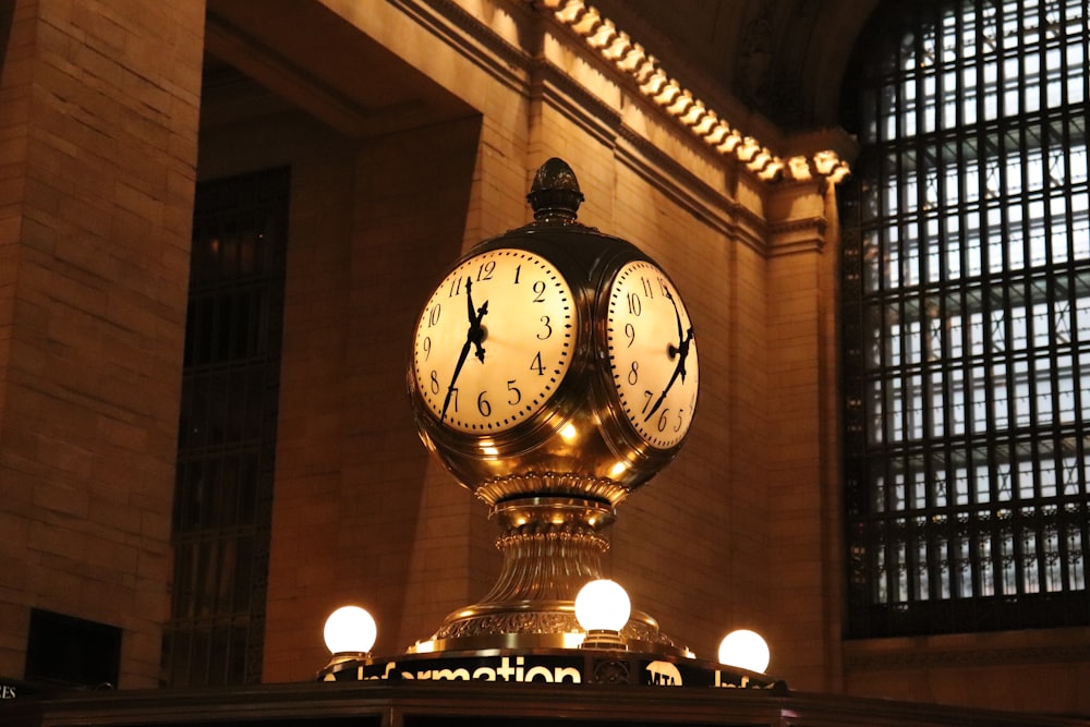 a clock in the middle of a train station
