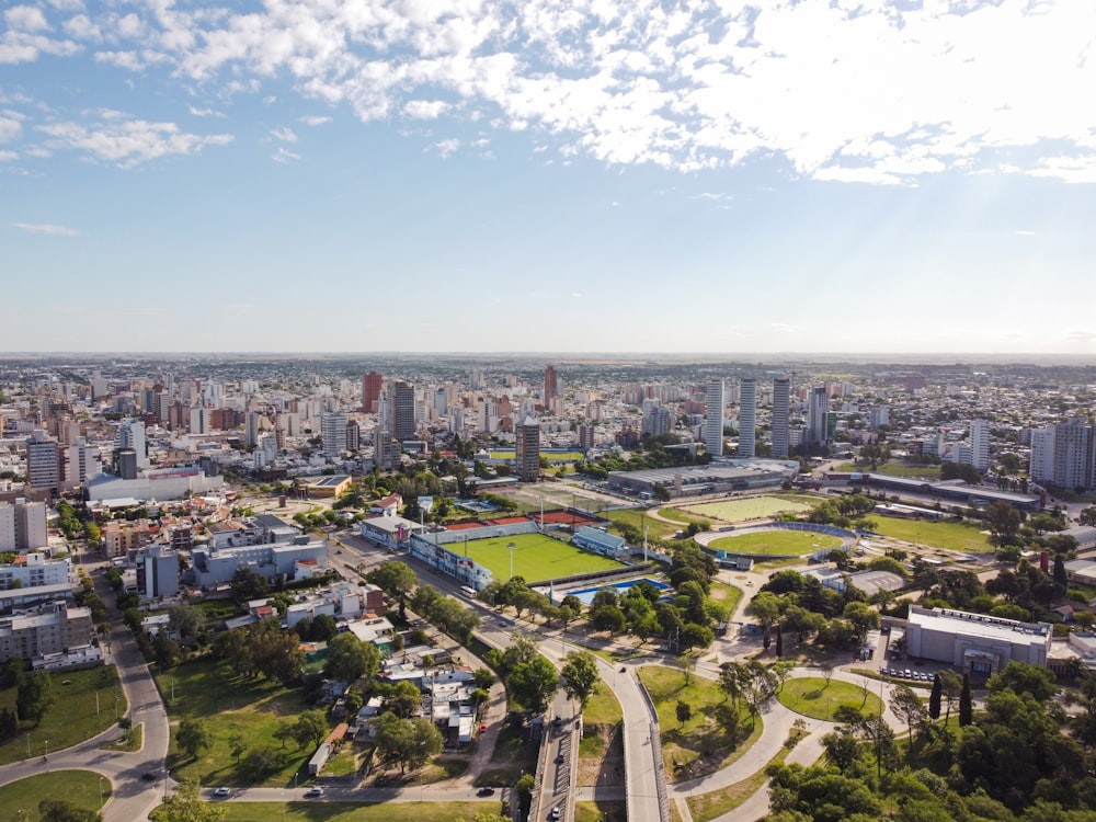 an aerial view of a city with a soccer field