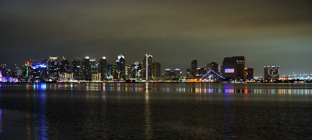 a city skyline is lit up at night