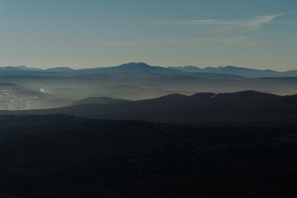 a view of a mountain range with a city in the distance