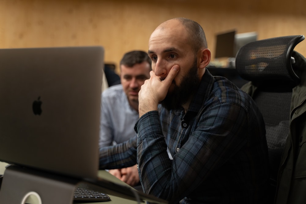 a man sitting in front of a laptop computer