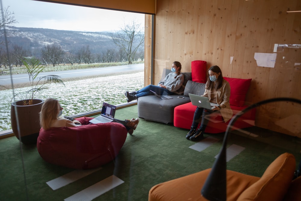 a group of people sitting on top of a couch in a living room