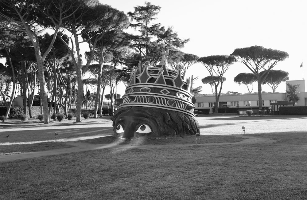 a black and white photo of a boat in the grass