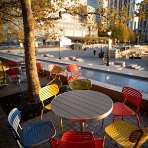 Empty chairs and empty tables as evening falls in Battery Park City, NY