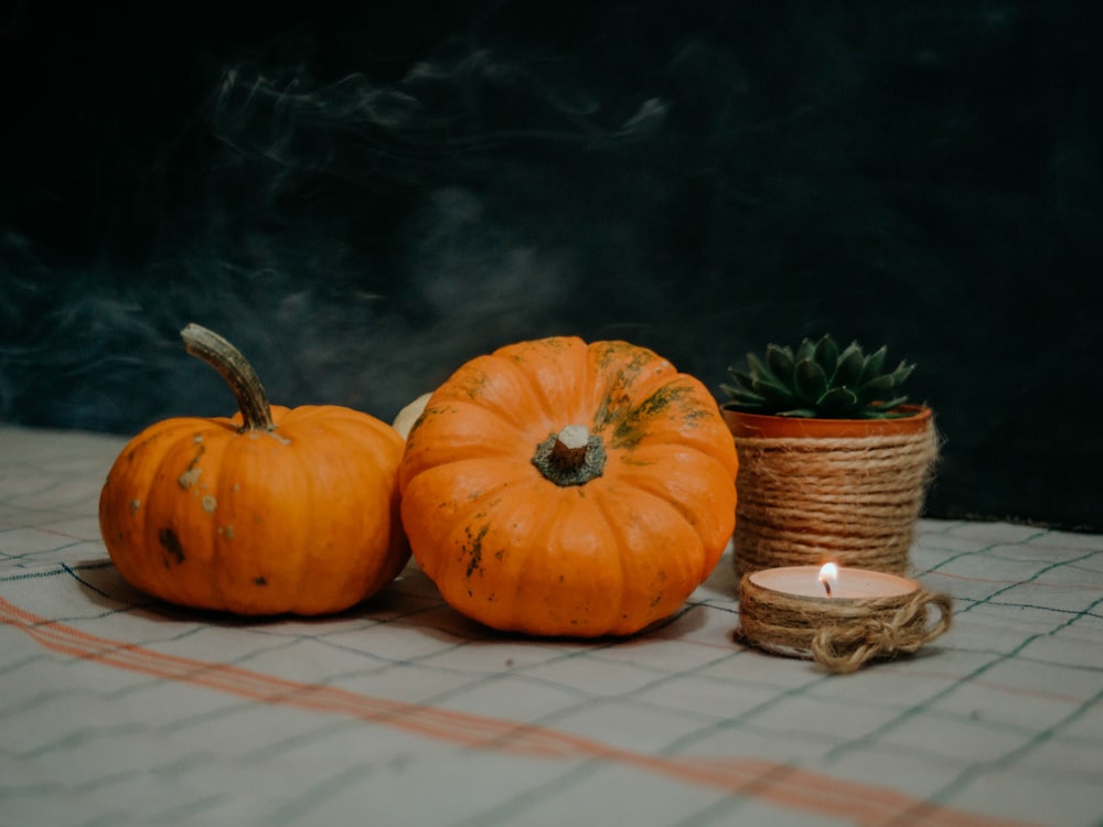 a couple of pumpkins sitting on top of a table