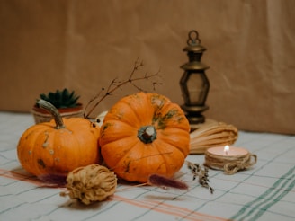 a table topped with lots of different types of pumpkins on a vintage decor