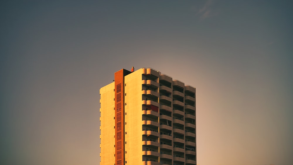 a tall building with a sky in the background
