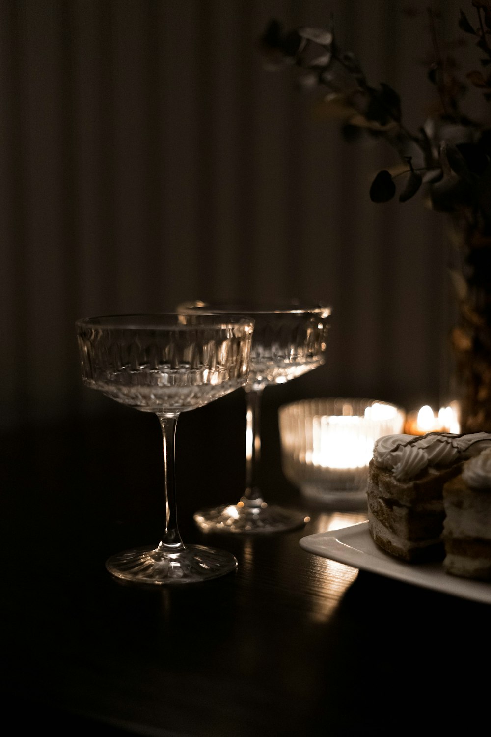 a table topped with a plate of food and a glass of wine