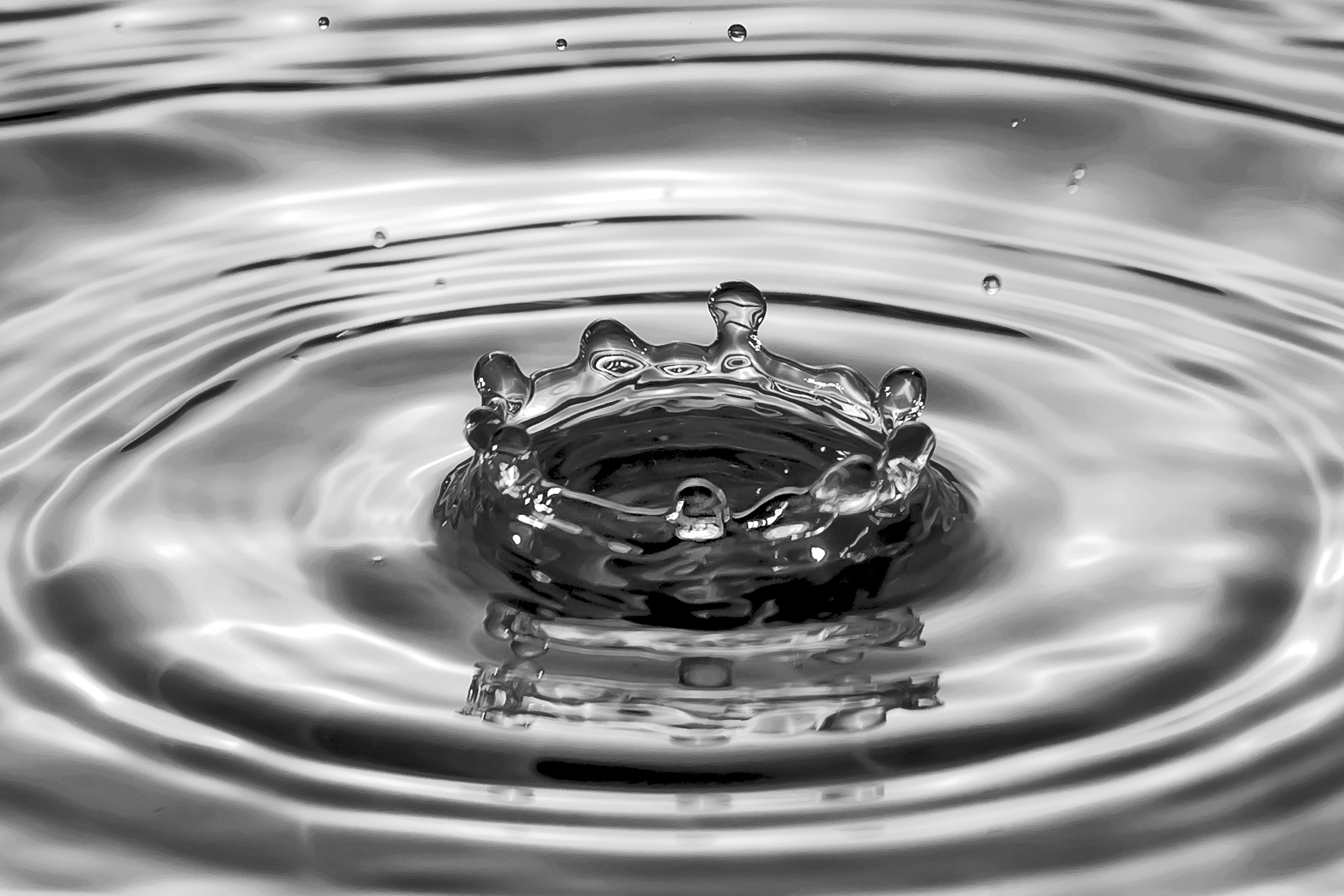 a black and white photo of a water drop