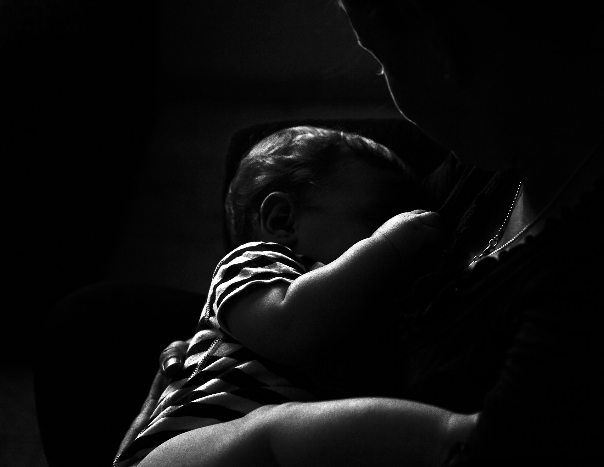 a man holding a baby in his arms