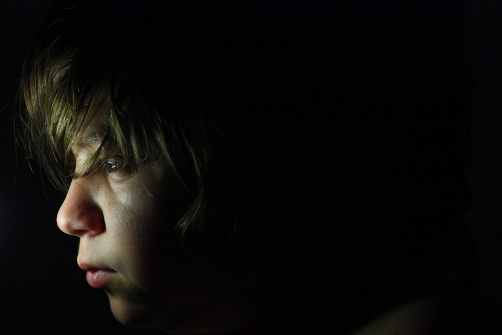 a close up of a person in the dark