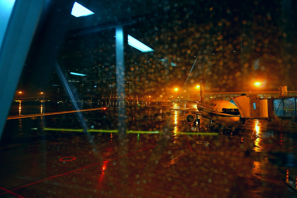 a plane is parked on the tarmac at night