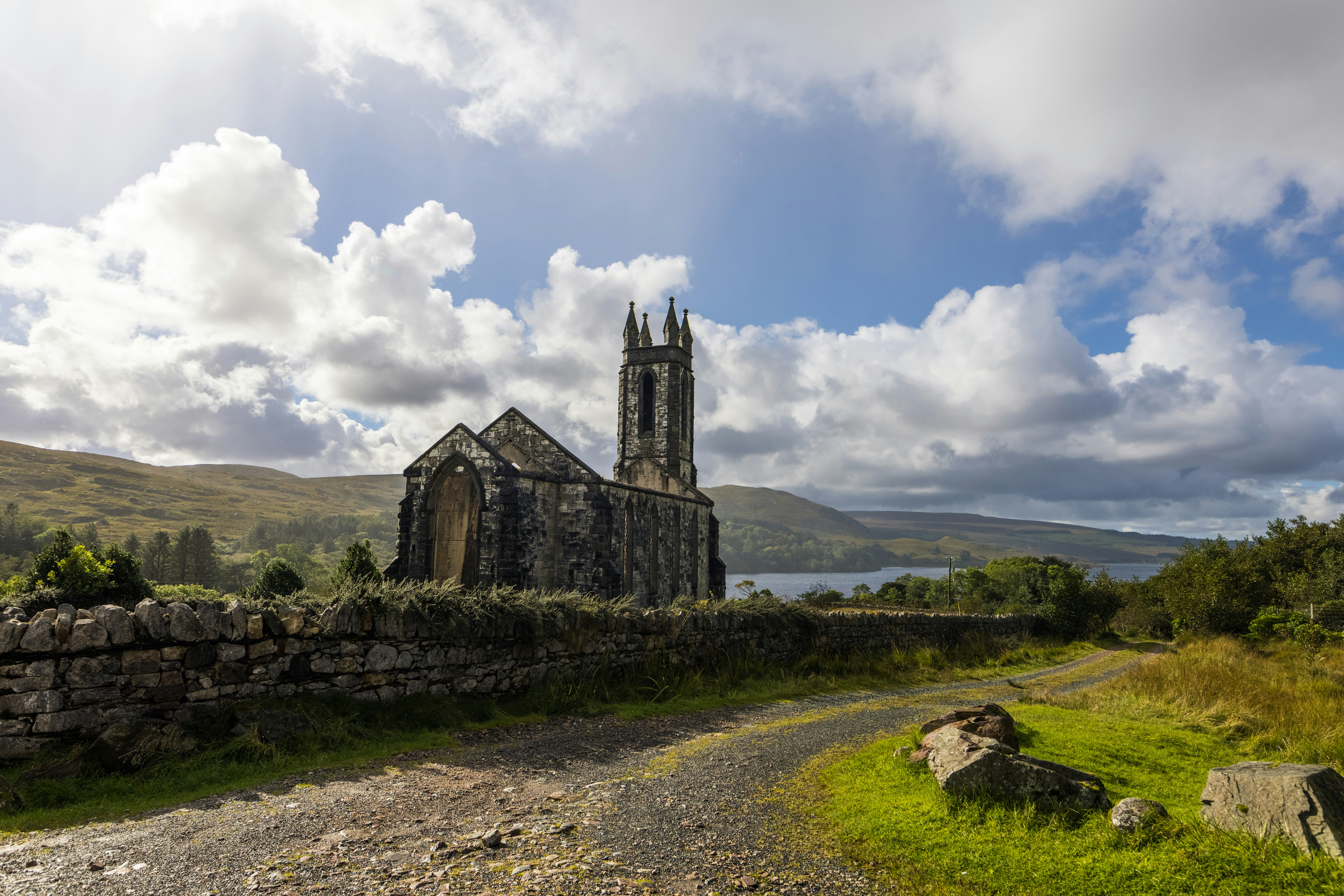 a large stone building sitting on top of a lush green field