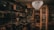 A dimly lit room filled with vintage electronics and furnishings. Old televisions and radios are neatly arranged on shelves alongside vintage typewriters. An ornate chandelier hangs from the ceiling, casting a warm glow throughout the room. Framed posters and records adorn the walls, contributing to an antique and nostalgic atmosphere.