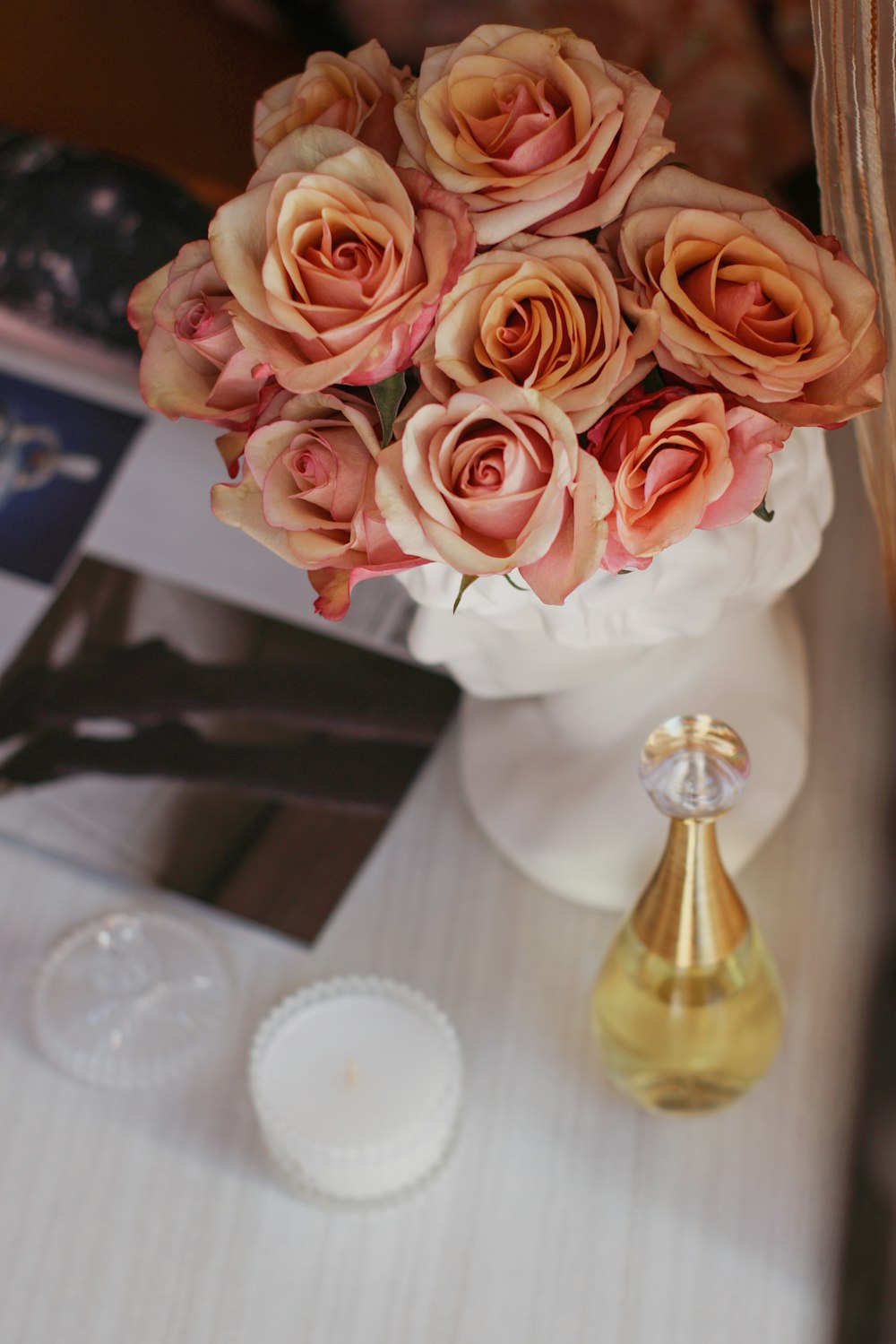 a vase filled with pink roses on top of a table