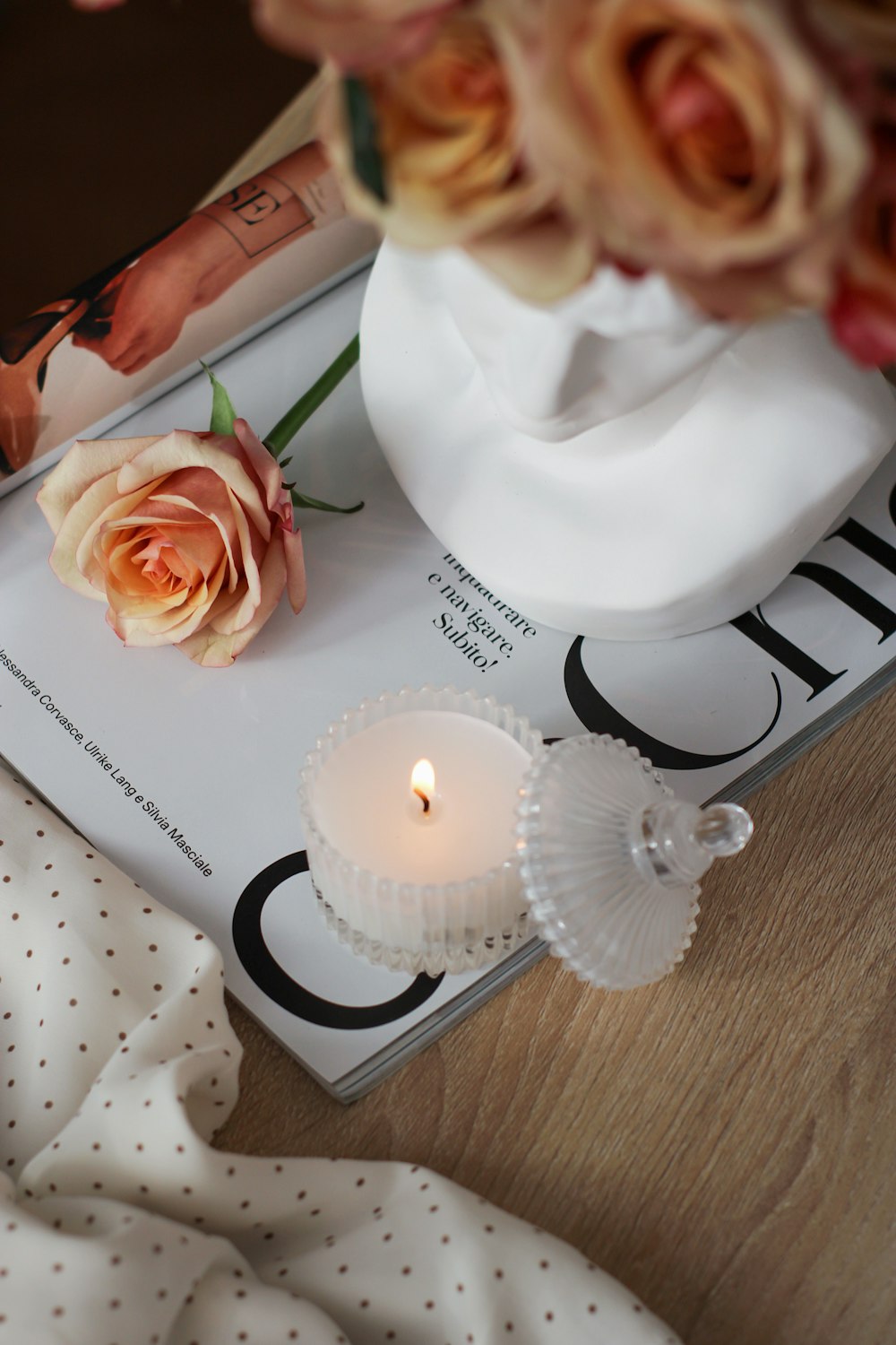a book with a rose and a candle on top of it