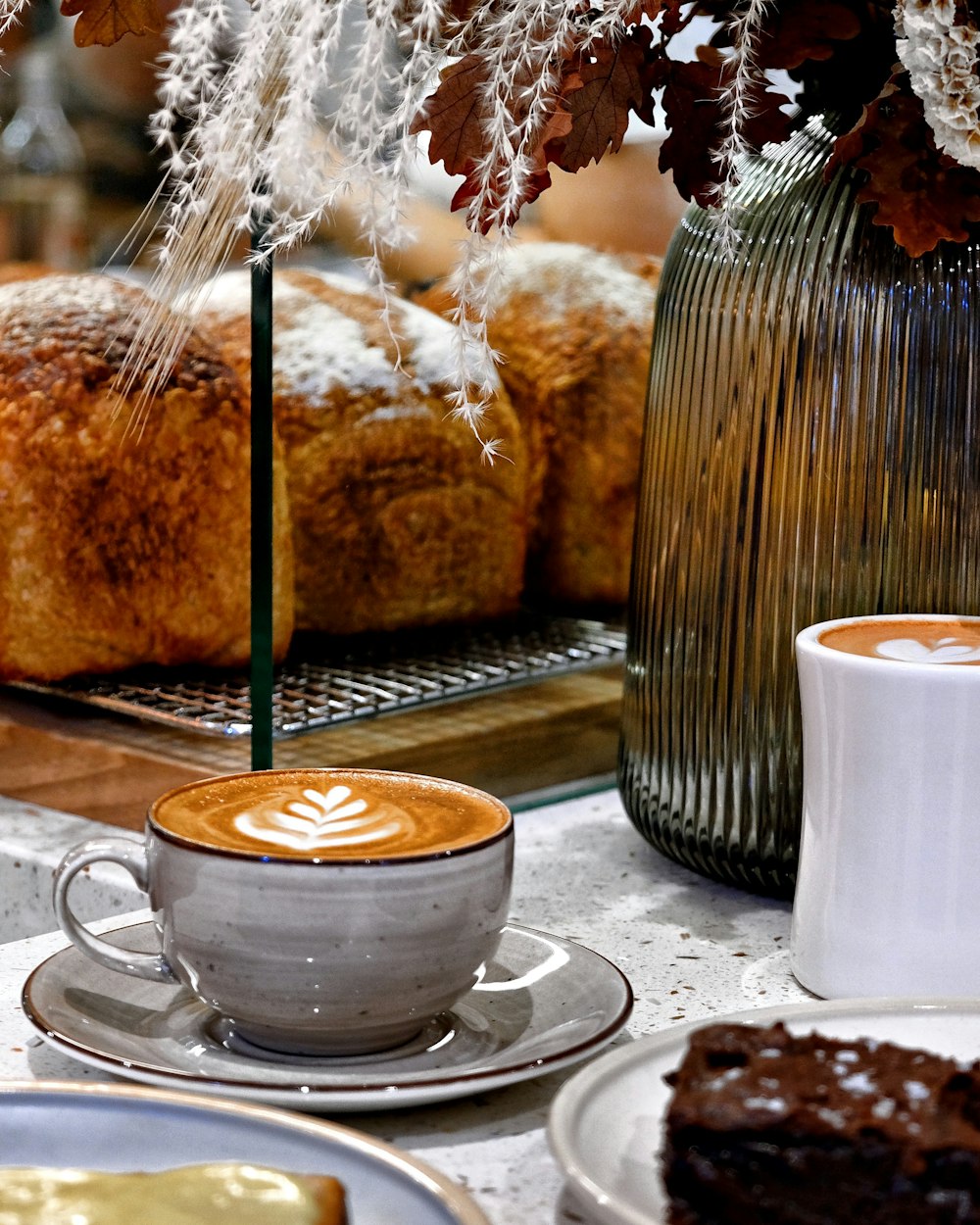 a table topped with plates of food and a cup of coffee