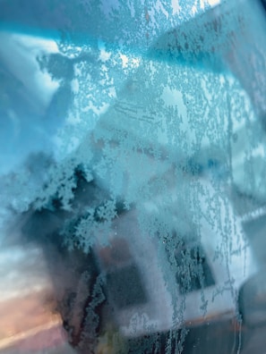 A peaceful scene of a sunset viewed through frosty glass.