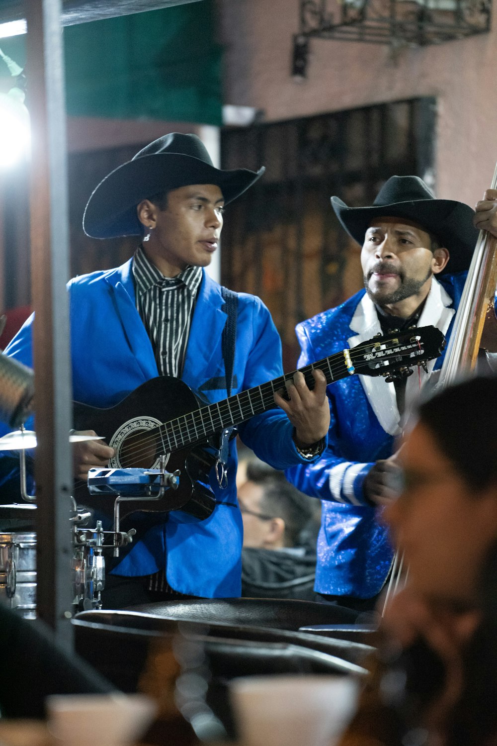 a couple of men that are playing guitars