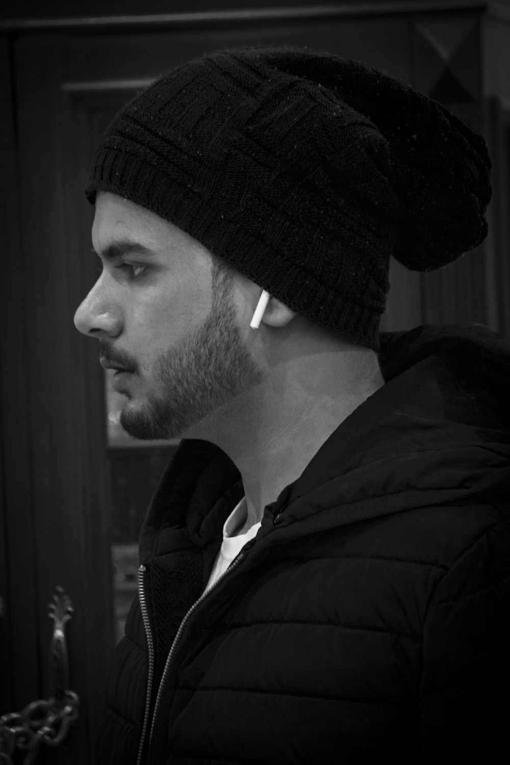 a man wearing a beanie and ear piercings