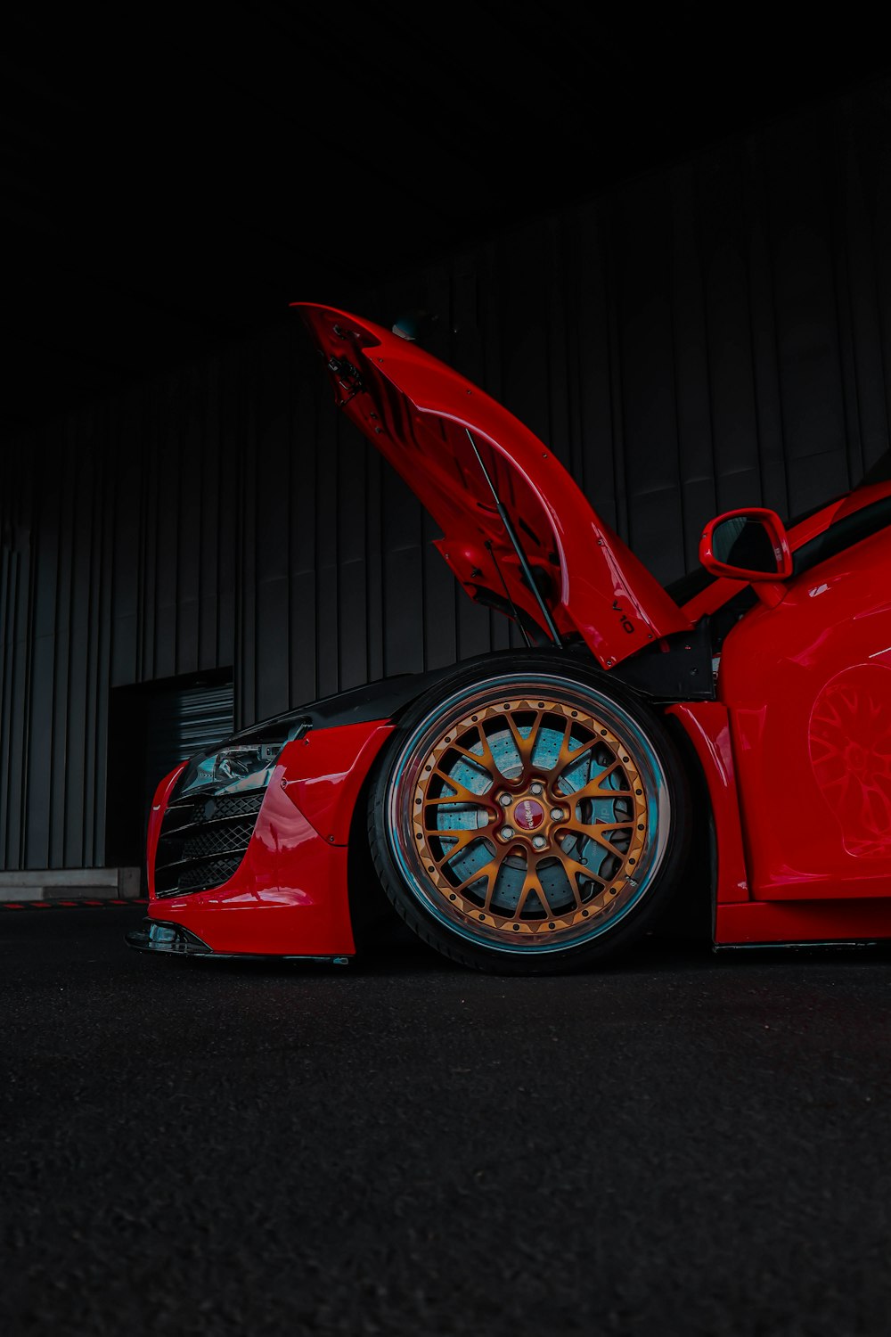 a red sports car with its hood open