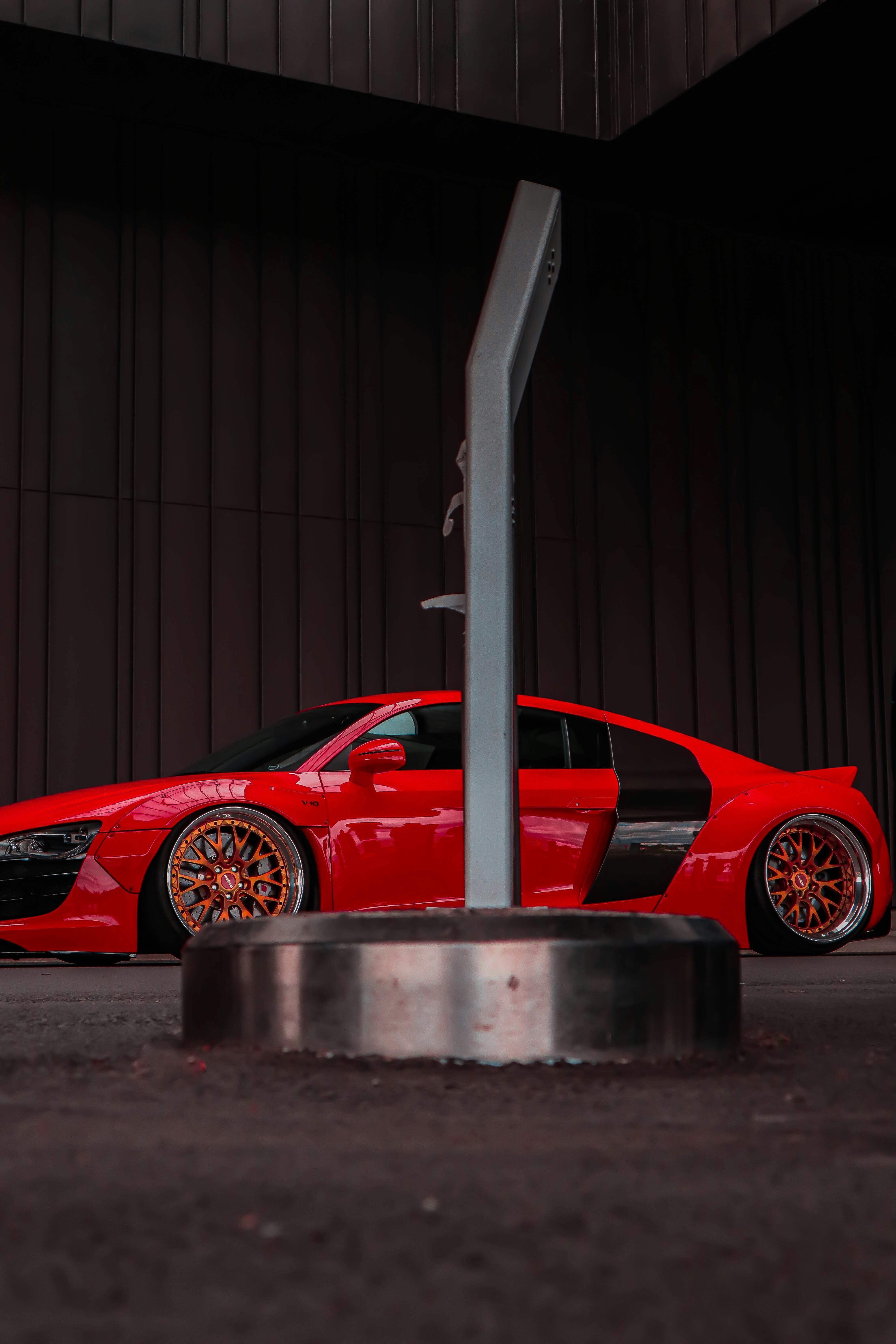 a red sports car parked in front of a building