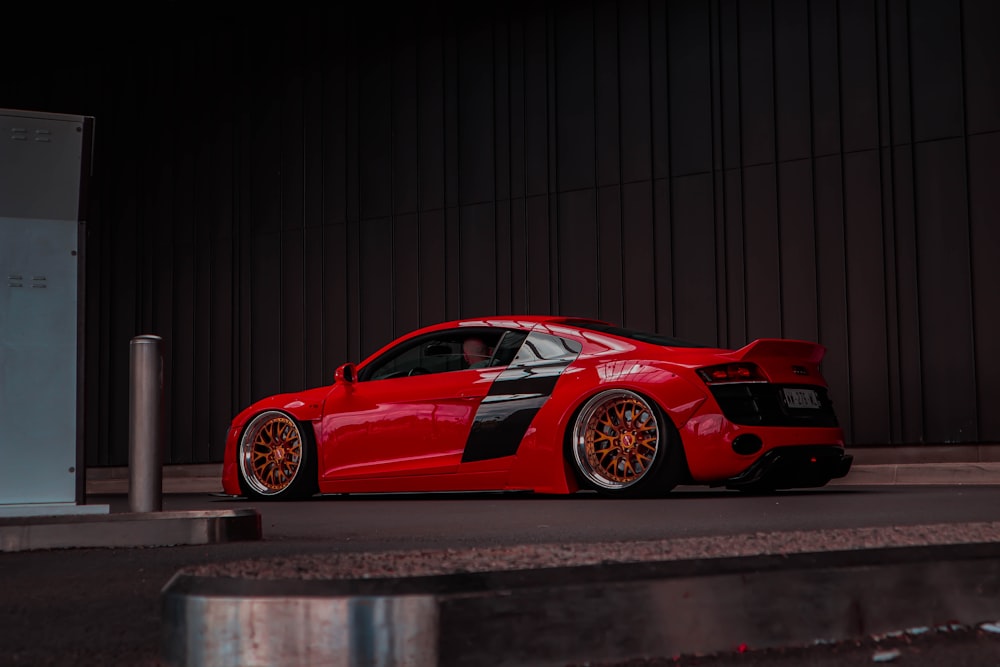 a red sports car parked in front of a building