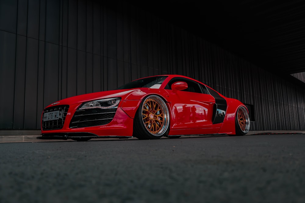 a red sports car parked in front of a building