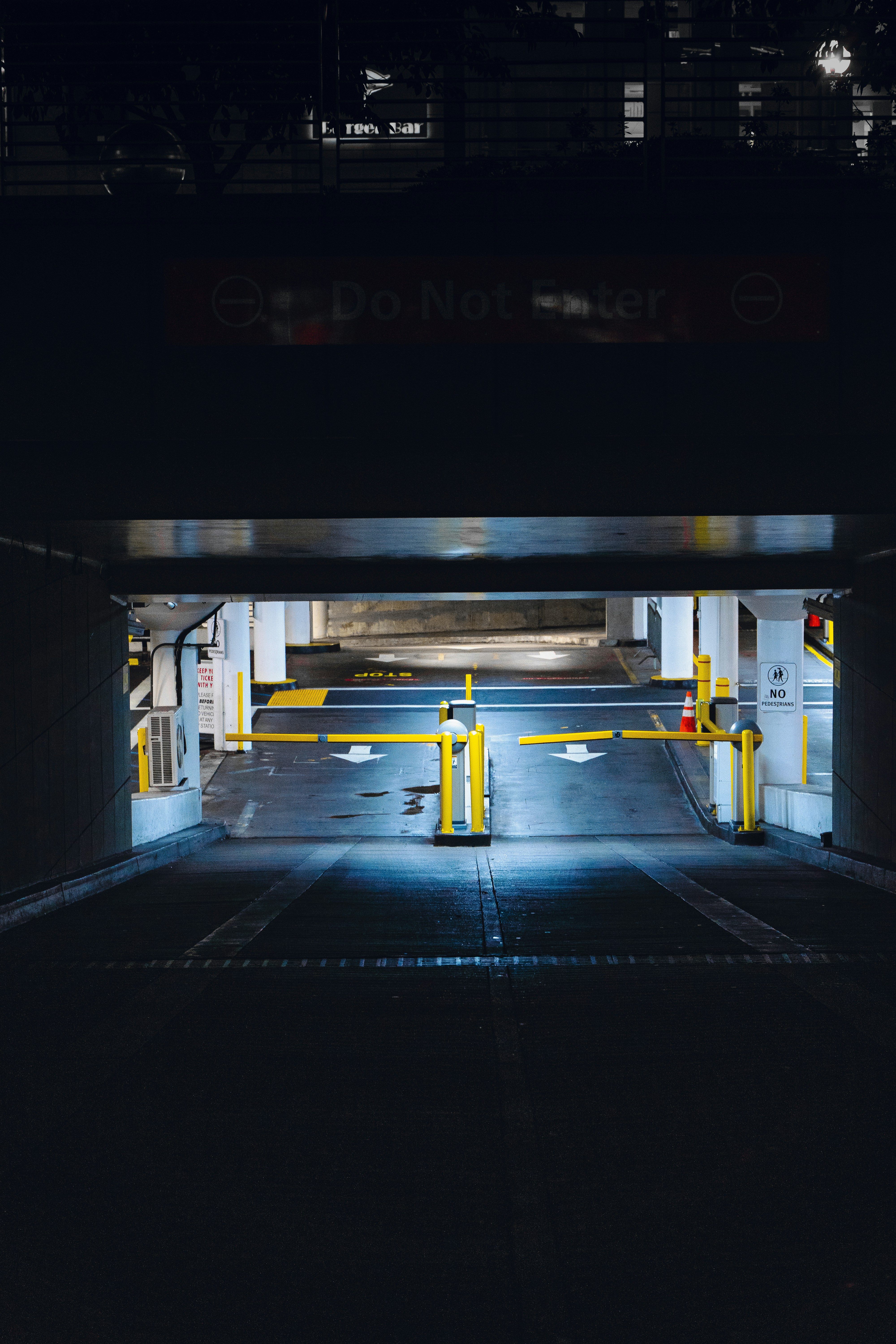an empty parking garage with yellow barriers