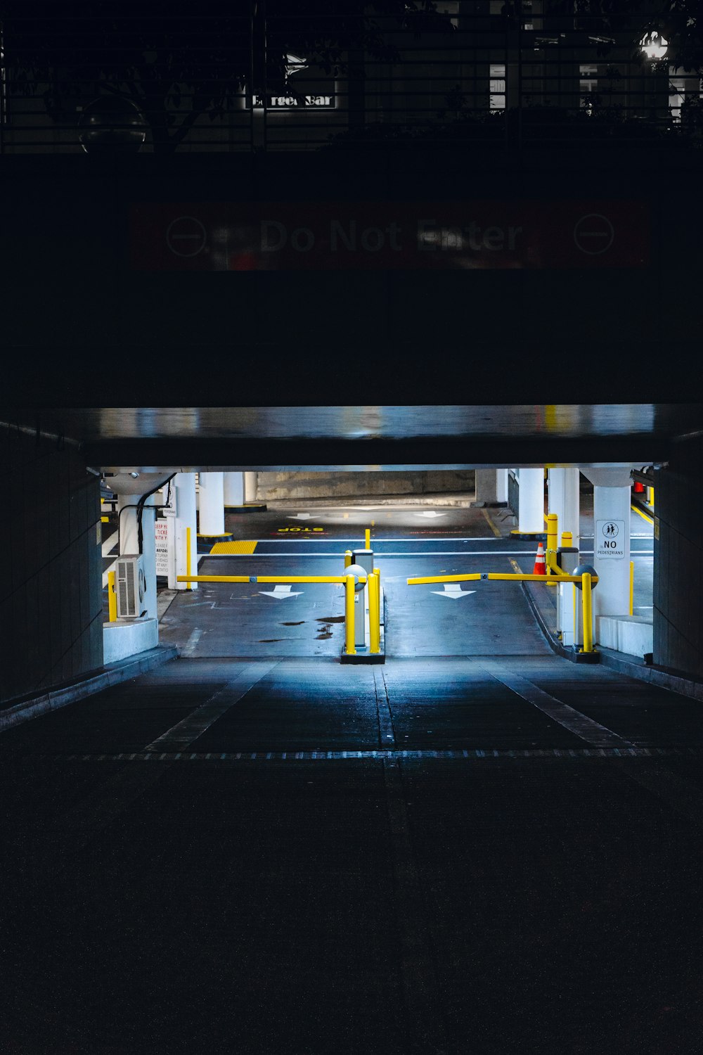 an empty parking garage with yellow barriers