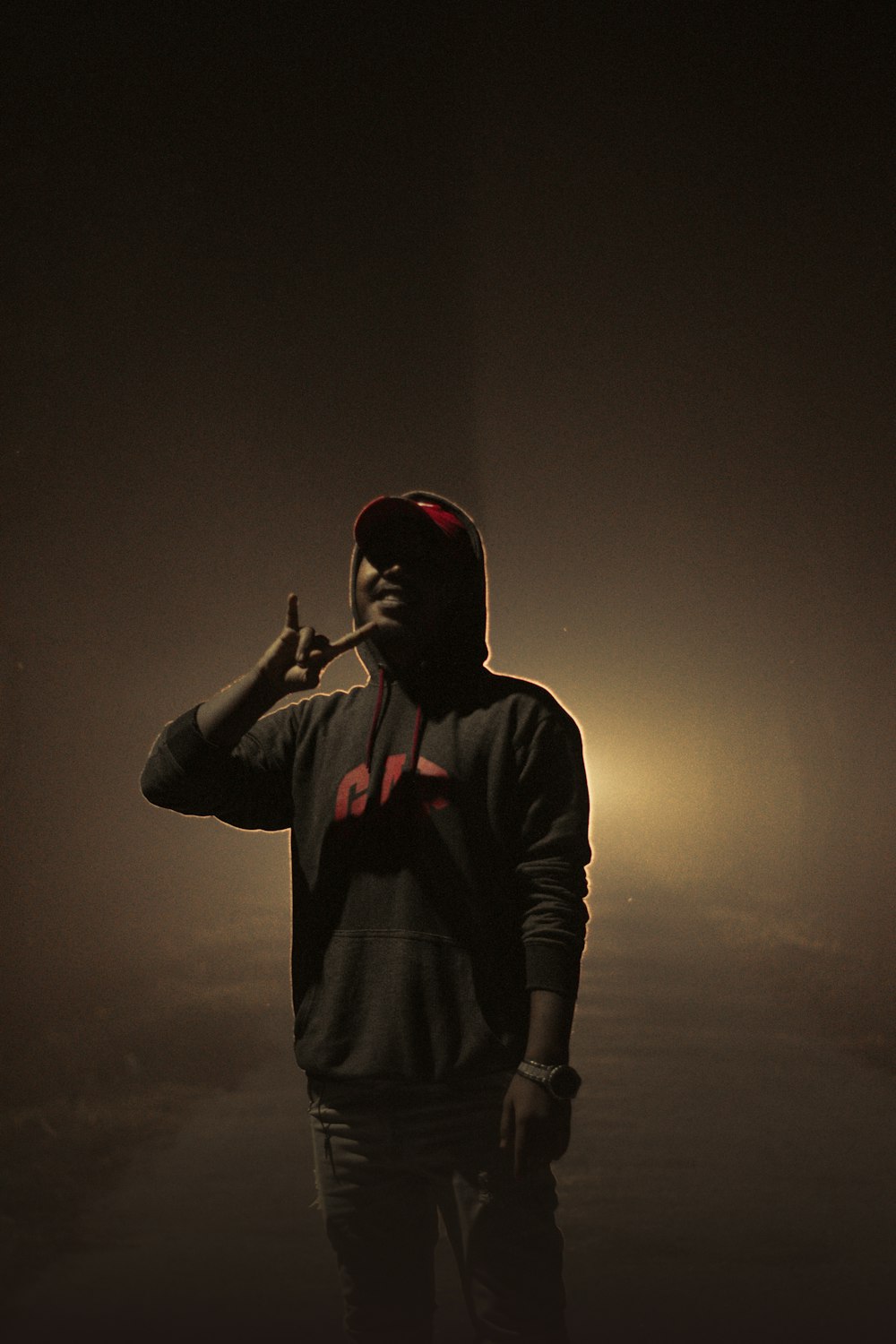 a man smoking a cigarette in the dark