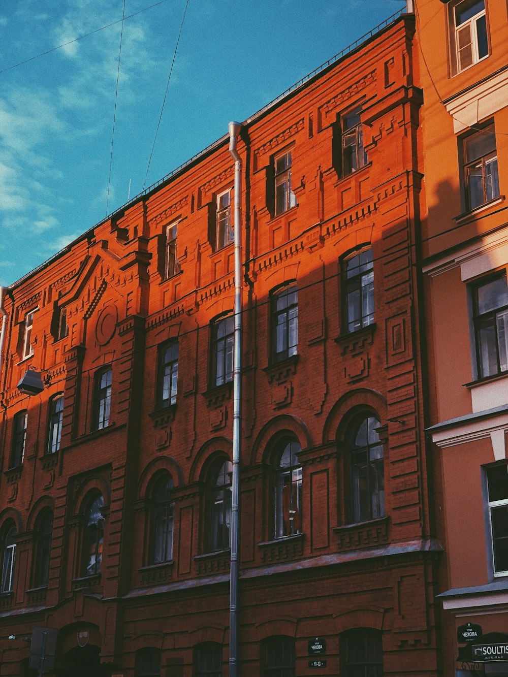 an orange building with a street light in front of it