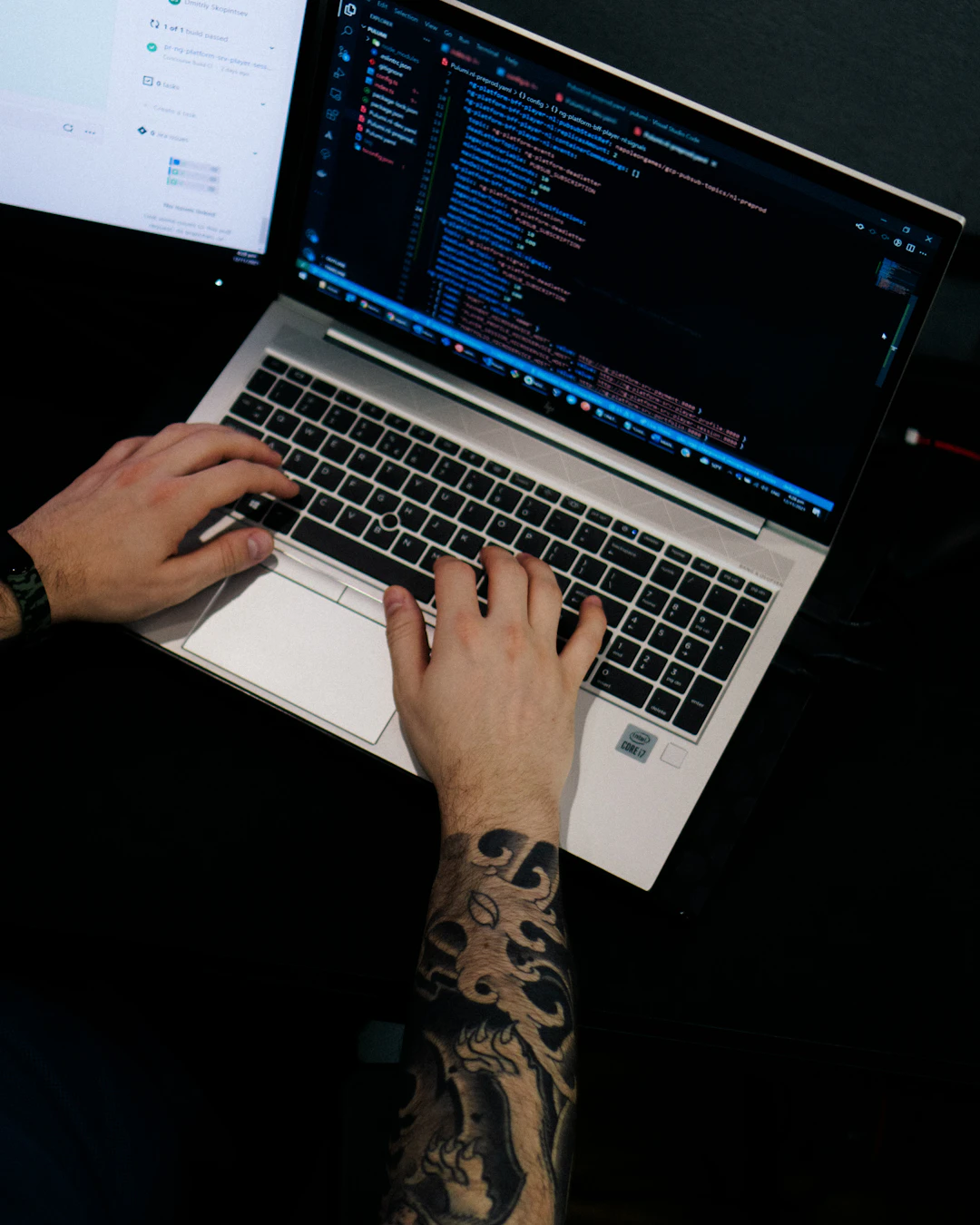 A developer coding on a laptop late at night