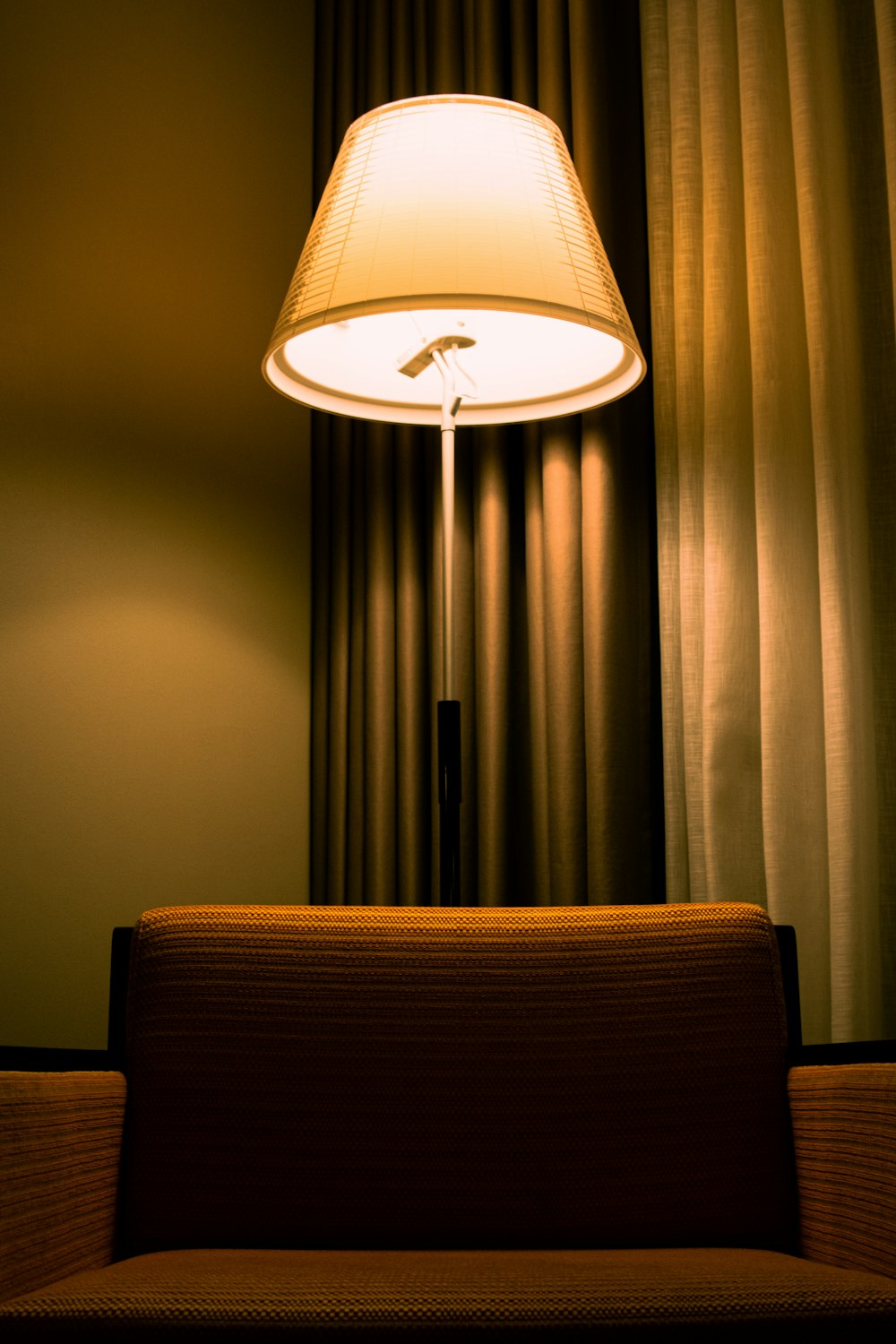 a lamp sitting on top of a table next to a couch
