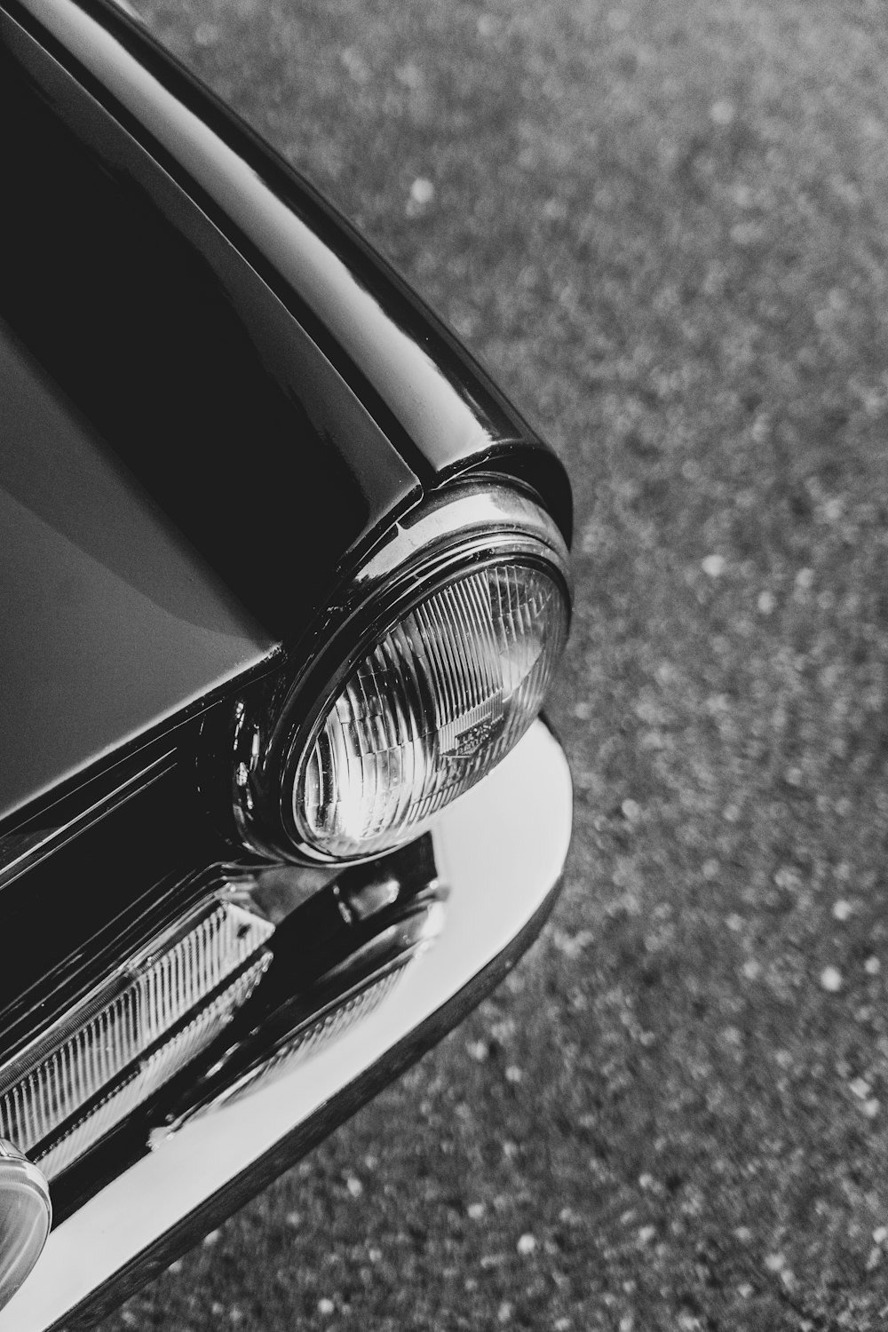 a black and white photo of a car headlight