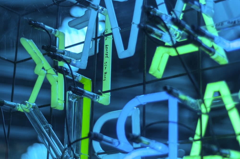 a group of neon signs hanging from the side of a building