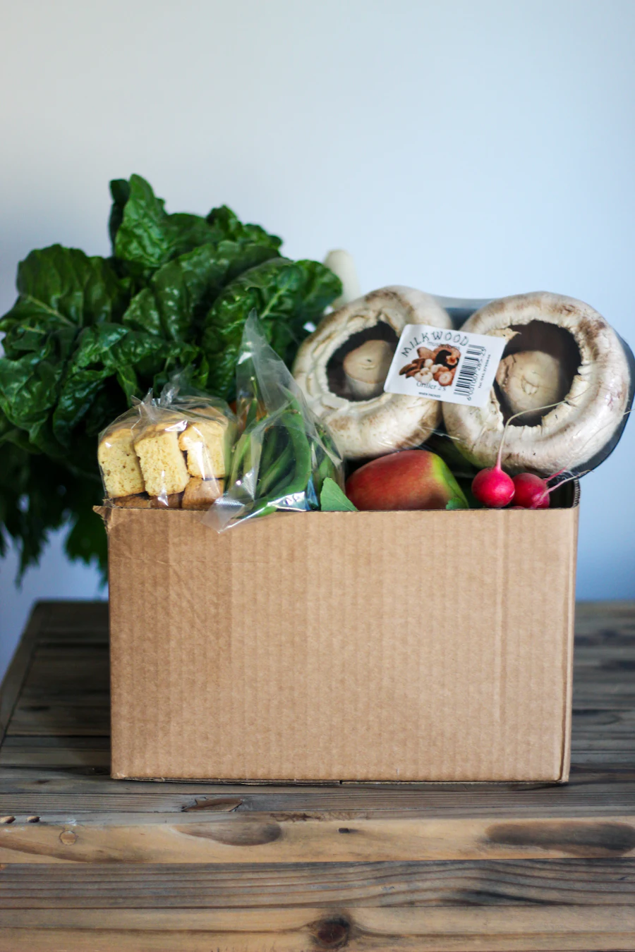 A donation box filled with fresh produce and groceries
