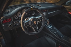 the interior of a car with a steering wheel and dashboard