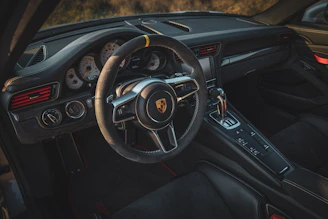 the interior of a car with a steering wheel and dashboard