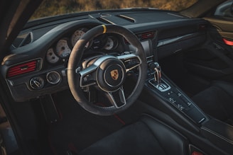 the interior of a car with a steering wheel and dashboard