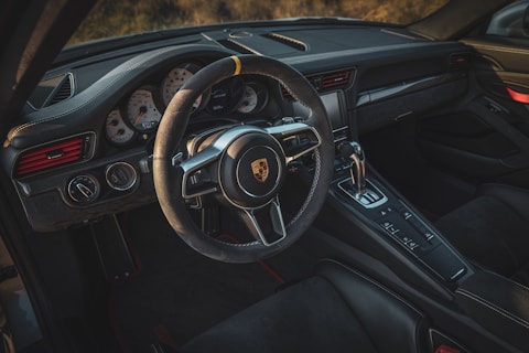 the interior of a car with a steering wheel and dashboard