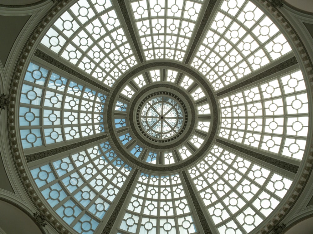 a view of the ceiling of a building with a circular glass window