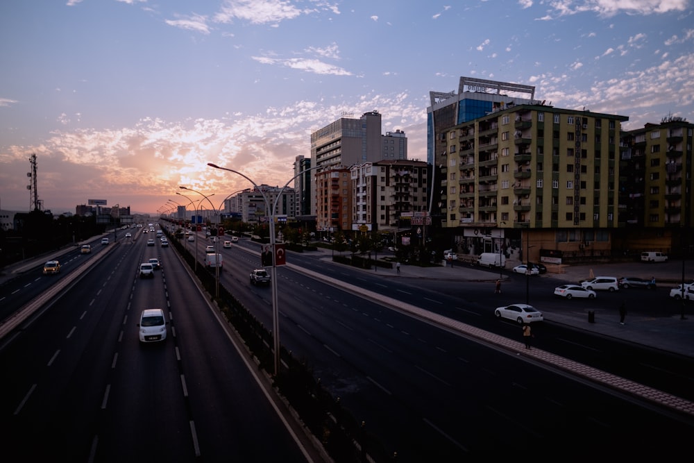 a view of a city street with many cars driving on a highway